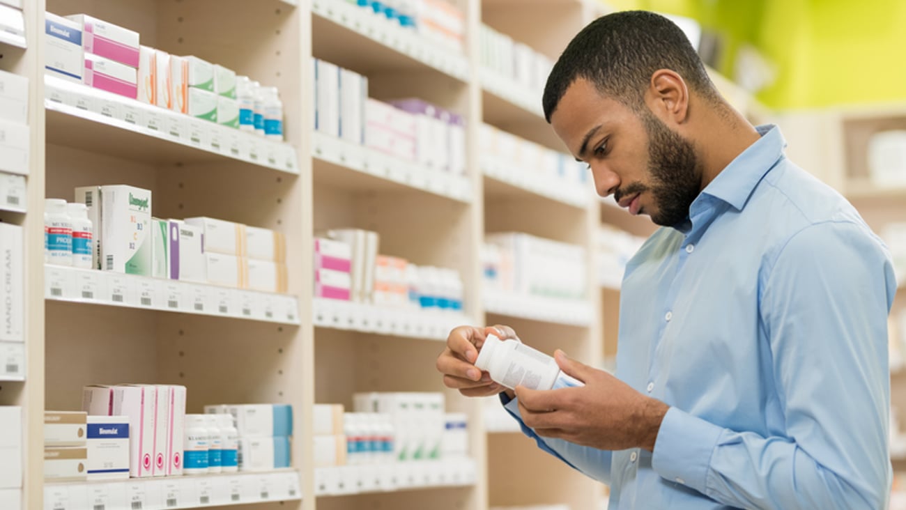 Un client regarde des produits dans une pharmacie.