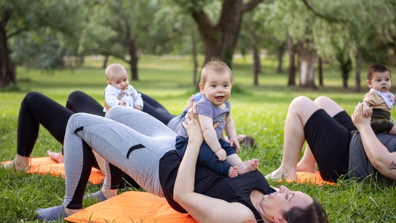 Un groupe de mère font de l'activité physique avec leurs bébés