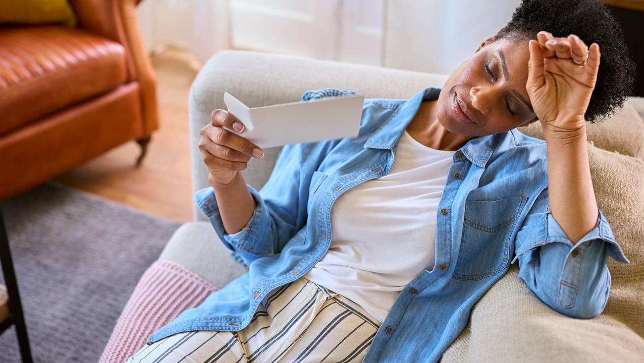 woman experiencing a hot flash as she lies down 