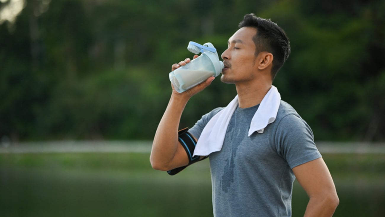 Un sportif boit un shaker protéiné