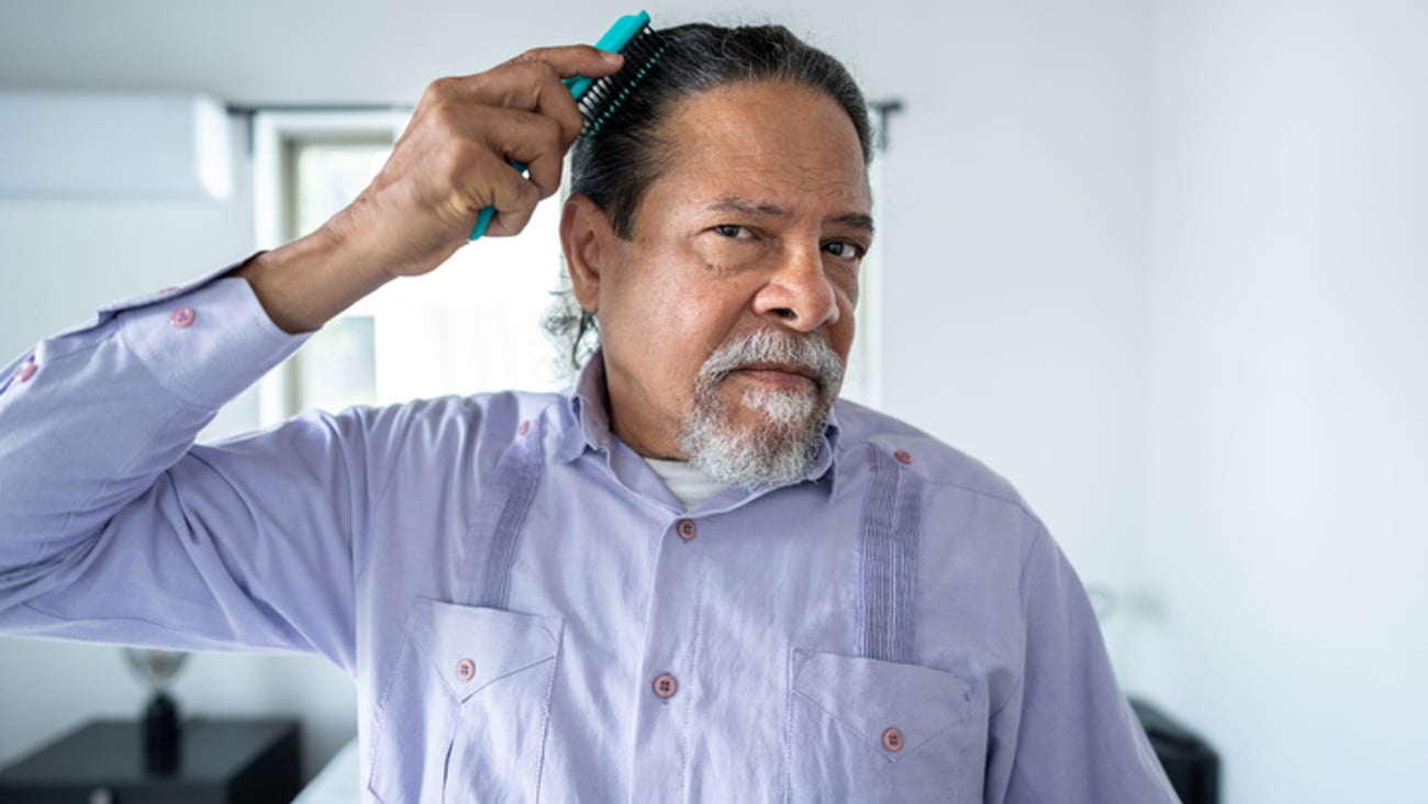Un homme se brosse les cheveux