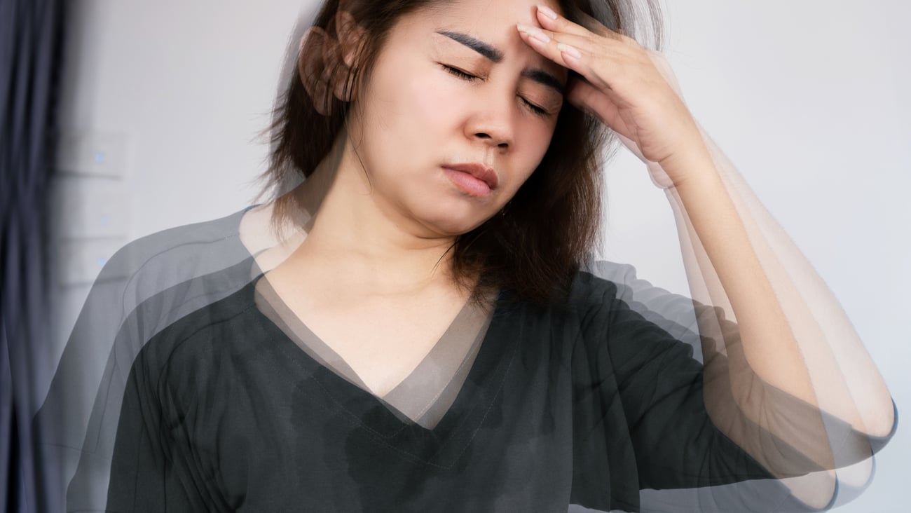 Dizzy woman holding her head