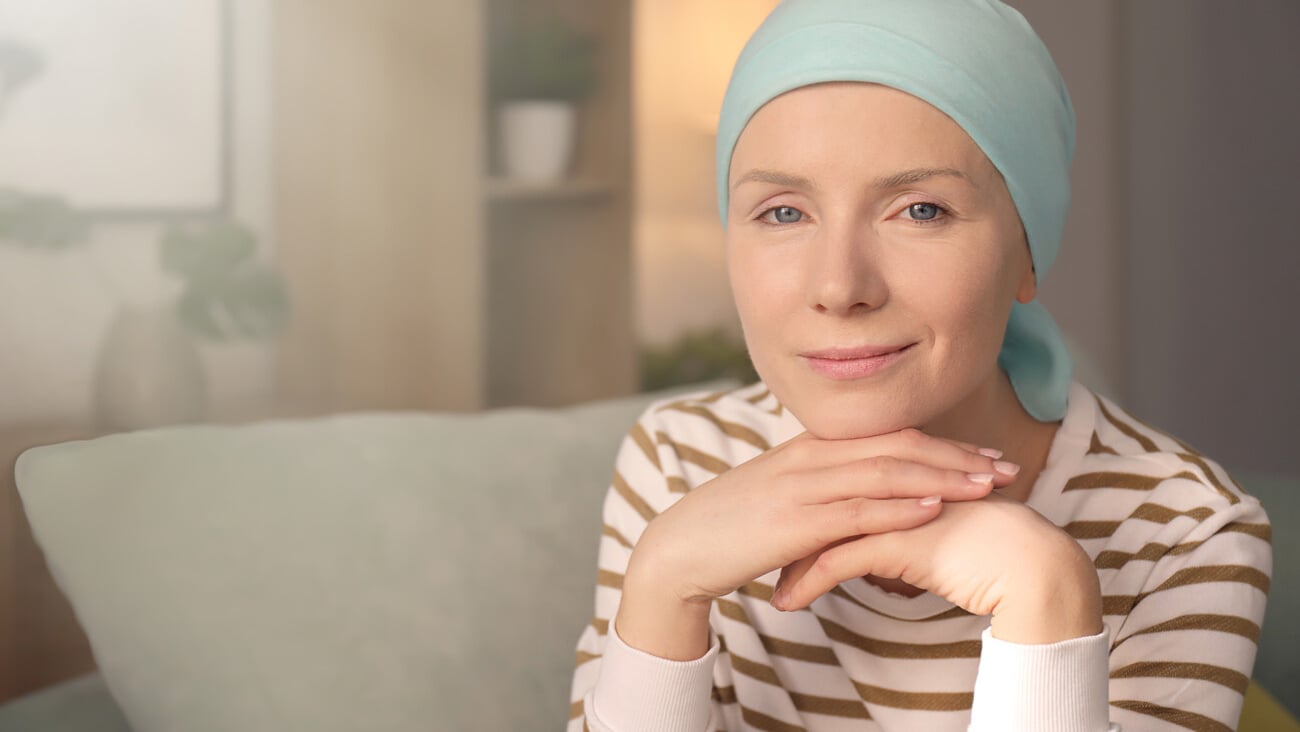 Young woman with cancer in headscarf indoors; Shutterstock ID 1046426491