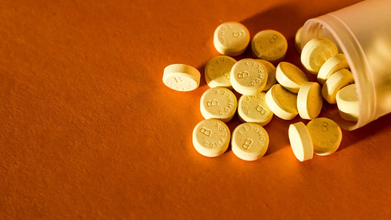 a vitamin B Complex pill that is yellow; Shutterstock ID 1737533588