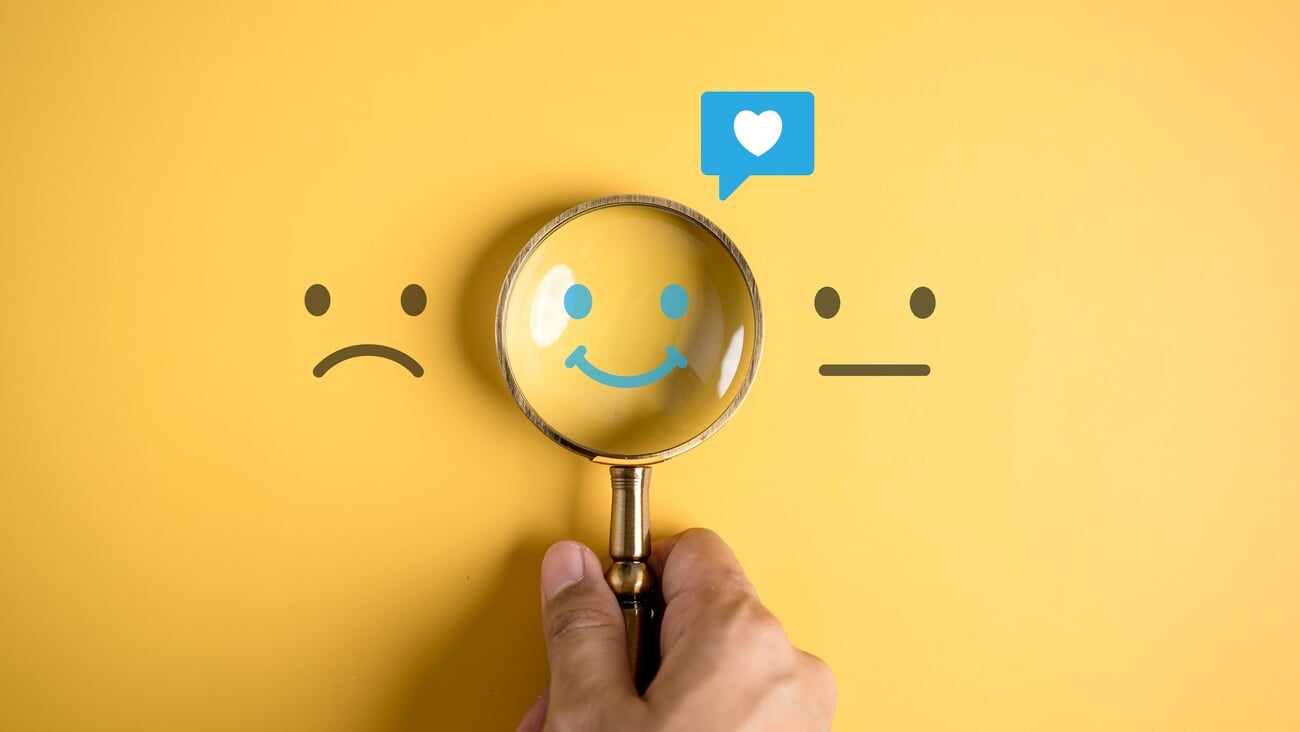 Smile happy face inside of magnifier glass with love icon massge between sad and normal emotion, Positive emotion, Mental health care concept.; Shutterstock ID 2256229555