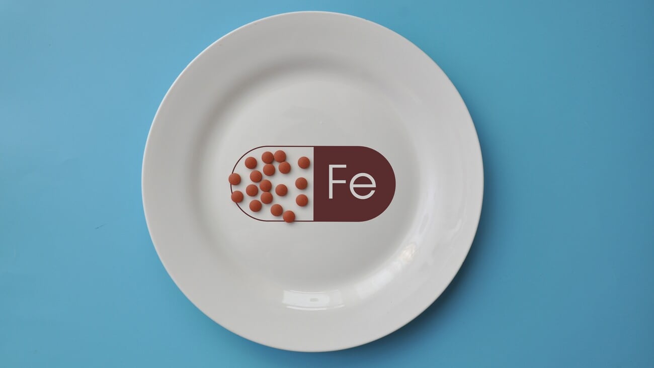 The mineral "iron" in tablets on a white plate. Iron deficiency in the body; Shutterstock ID 2454401005
