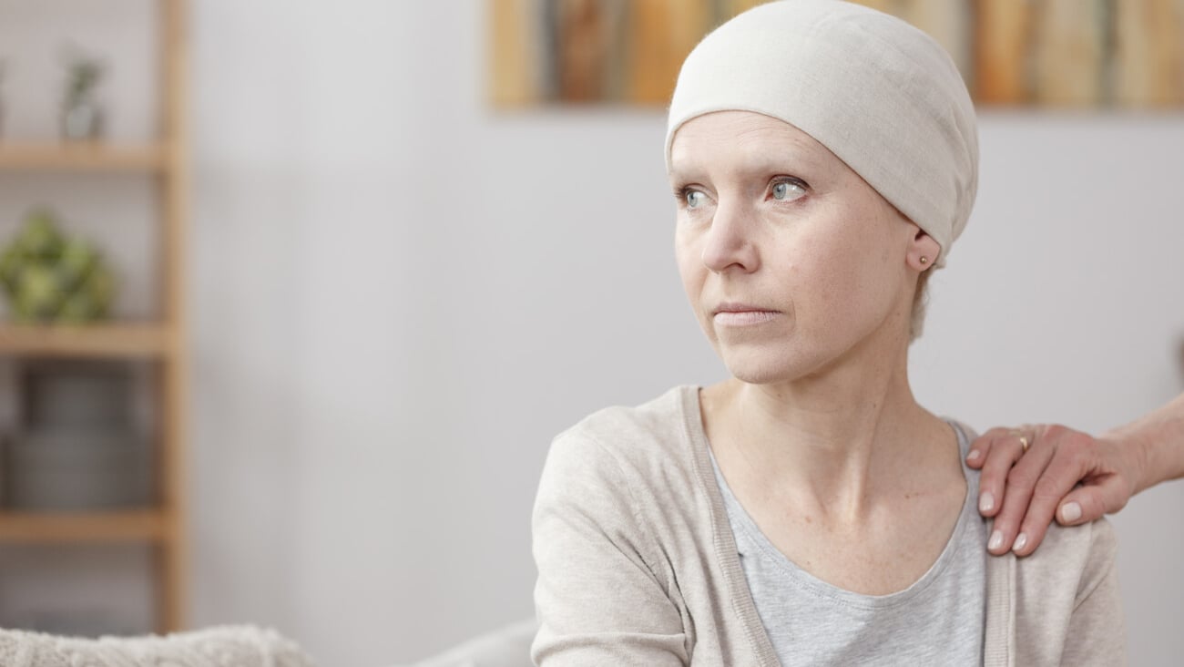 Sad sick woman with lung cancer sitting at home with friend; Shutterstock ID 689981449