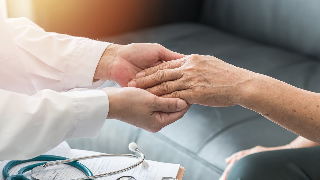 Geriatric doctor (geriatrician) consulting and diagnostic examining elderly senior adult patient (older person) on aging and mental health care in medical clinic office or hospital examination room  ; Shutterstock ID 700156936