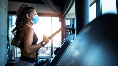 Une femme s'entraîne à la course à pied sur un tapis roulant.