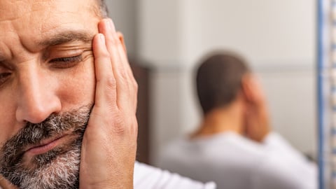 Un homme ressent une douleur à la mâchoire