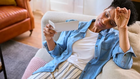 woman experiencing a hot flash as she lies down 