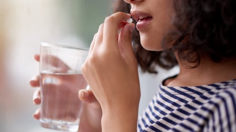 woman taking oral pill