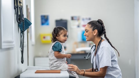 Une jeune enfant est en consultation avec une médecin ou une infirmière dans une clinique.