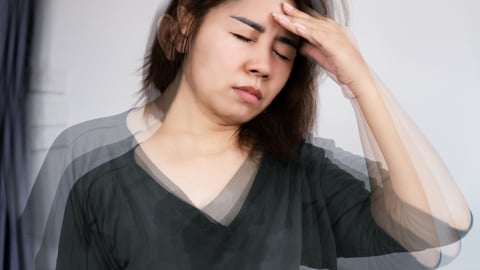 Dizzy woman holding her head