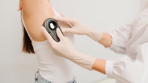 Dermatologue utilisant un dermascope