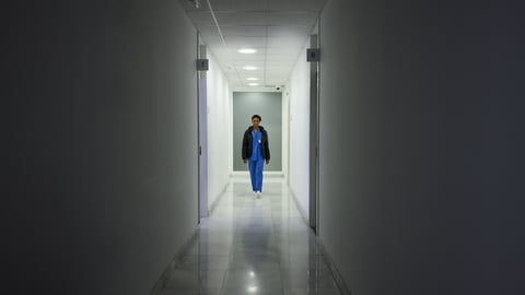 Médecin dans un couloir sombre d'hôpital