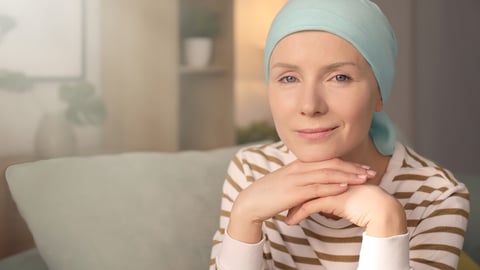Young woman with cancer in headscarf indoors; Shutterstock ID 1046426491