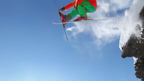 Skier jumping though the air from the cliff in high mountains; Shutterstock ID 112724215