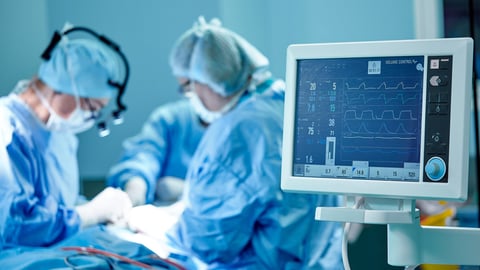 A surgeon's team in uniform performs an operation on a patient at a cardiac surgery clinic. Modern medicine, a professional team of surgeons, health.; Shutterstock ID 1438390733