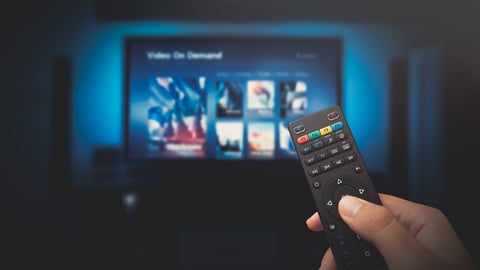 VOD service screen. Man watching TV with remote control in hand.; Shutterstock ID 1460184944