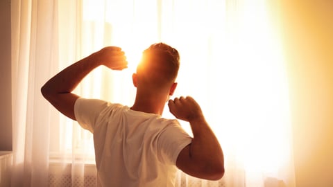 Man stretching near window at home, view from back. Lazy morning; Shutterstock ID 1631578165