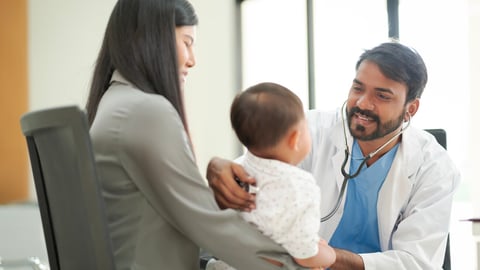 A kind doctor who treats pediatric patients. The child and his family brought him to see the doctor at the hospital because he was ill.; Shutterstock ID 2268919809