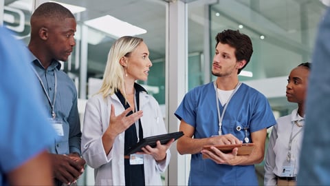 Doctors, group and meeting on tablet for medical planning, advice and support in teamwork or hospital solution. Healthcare staff, people and leader on digital technology and talking of clinic results; Shutterstock ID 2449222117