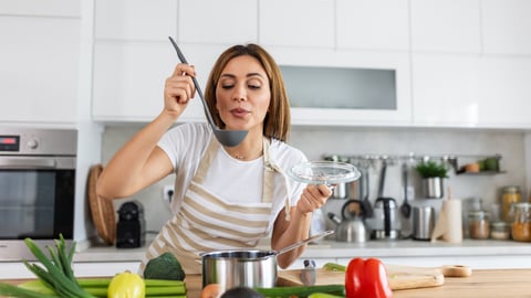Happy Young Woman Cooking Tasting Dinner In A Pot Standing In Modern Kitchen At Home. Housewife Preparing Healthy Food Smiling . Household And Nutrition. Dieting Recipes Concept; Shutterstock ID 2480820685