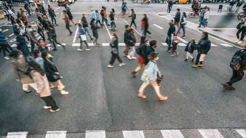 Une foule masquée traverse tranquillement la rue