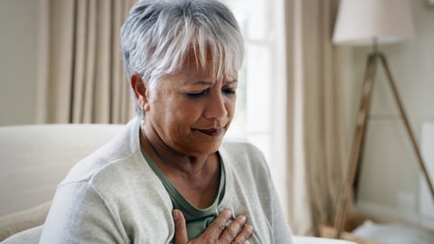 Older woman holding her chest