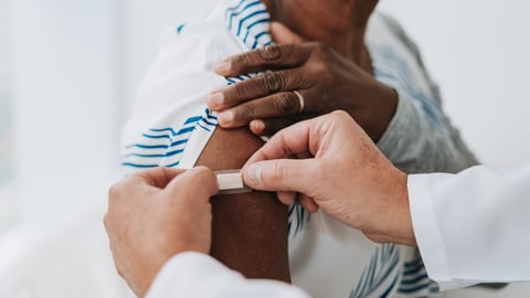 sticking bandaid onto flu shot area