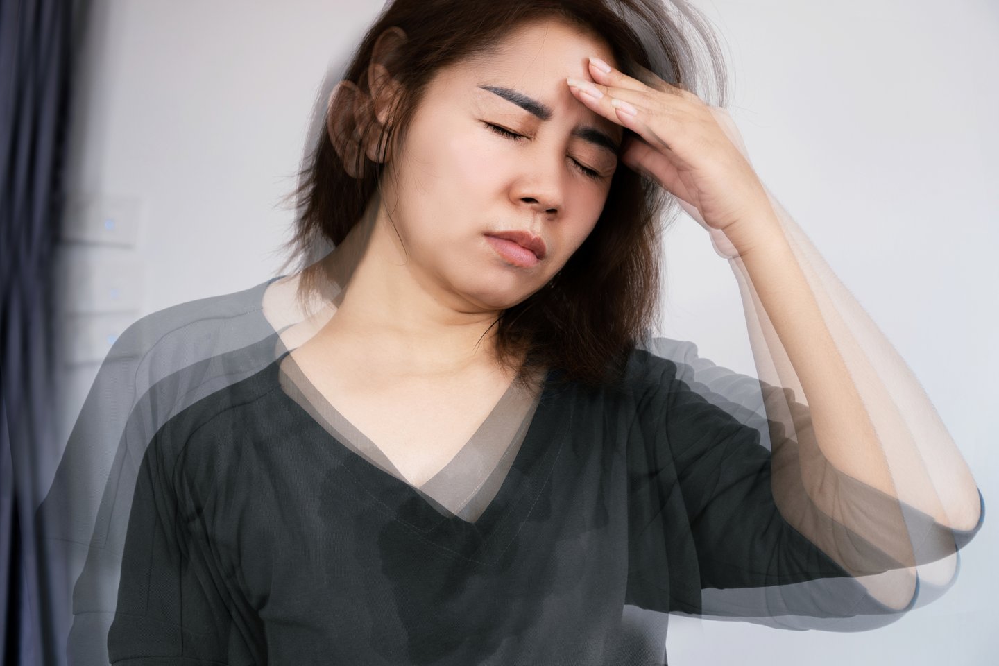 Dizzy woman holding her head