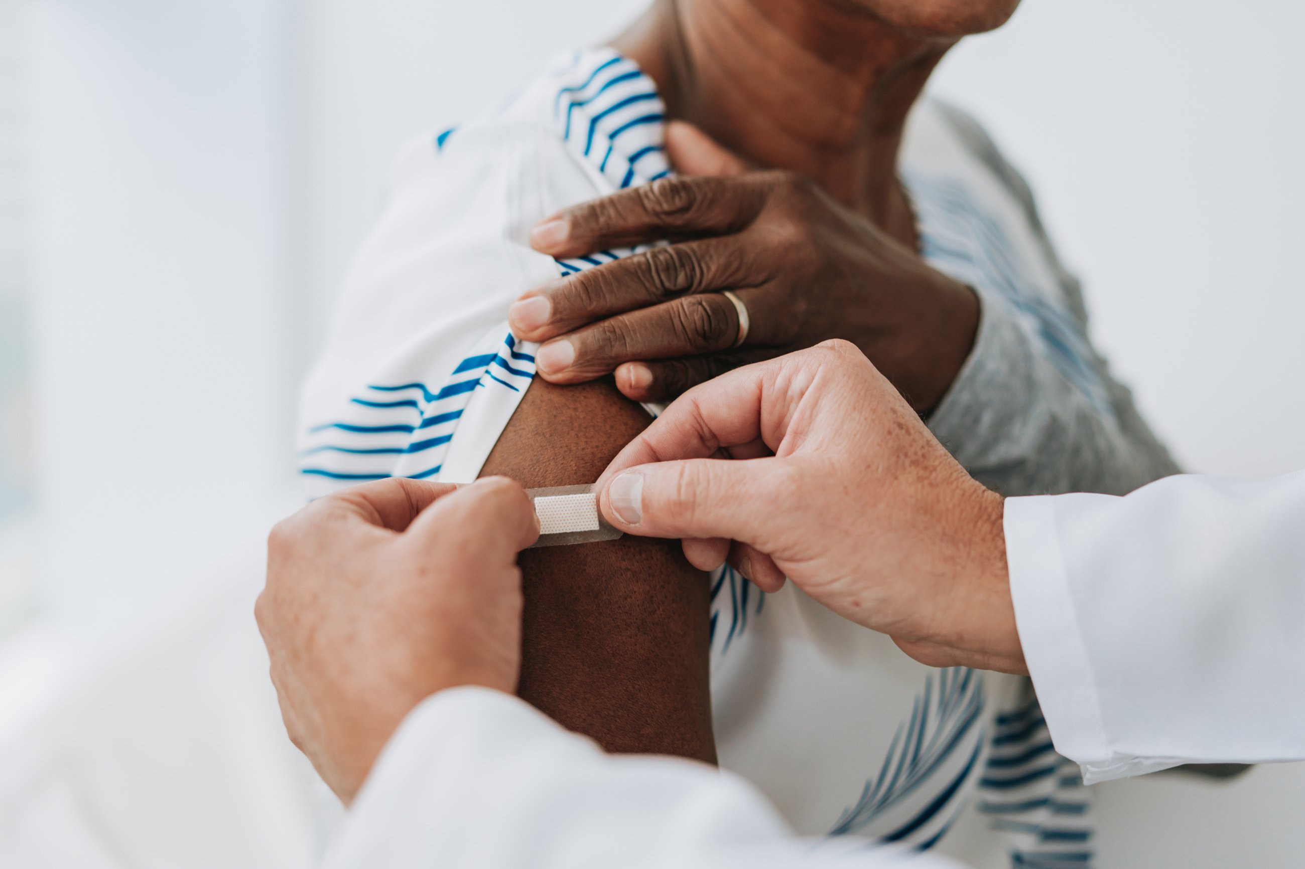 sticking bandaid on flu shot area